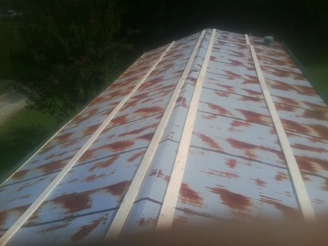 Rusted metal roof panels with new wood purlins before replacement — Storm Damage Roof Repair in Port Ewen by Roofing Brothers